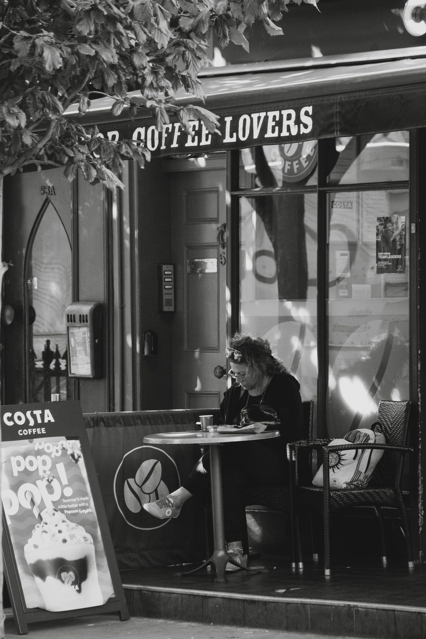 Individual in North Acton approaching individuals near Costa Coffee